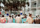A group of people sitting next to a swimming pool